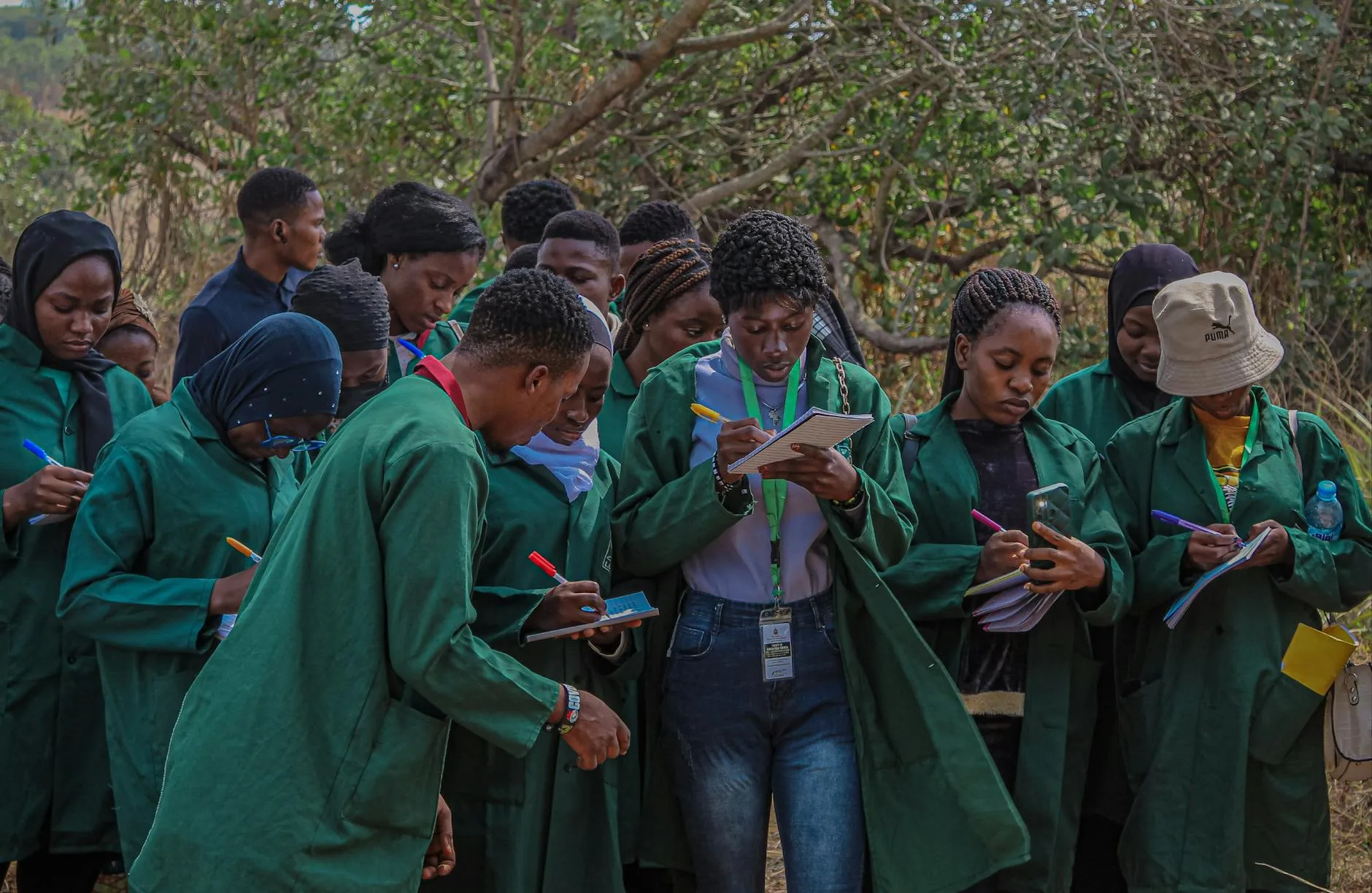 Pesquisadora com prancheta fazendo anotações em ambiente externo