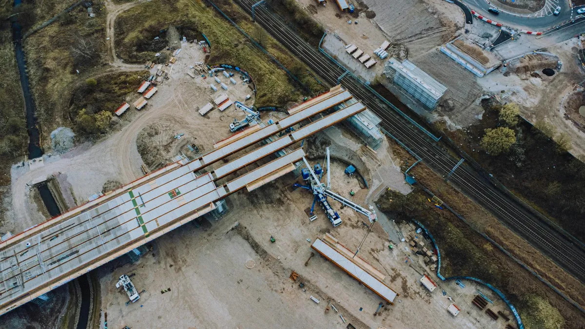 Engenheiros civis analisando plantas e projetos em mesa de trabalho universitária