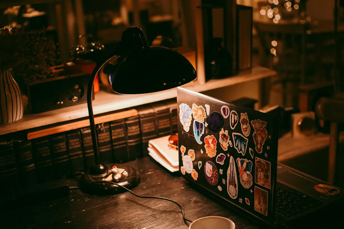 Mesa de estudo organizada com notebook, cadernos e plantas para home office acadêmico