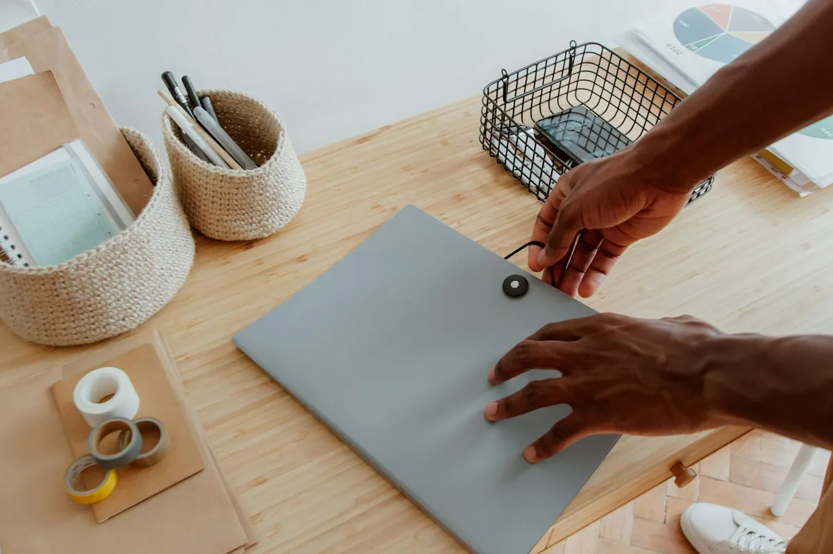 Profissional organizando documentos e anotações em mesa com livros acadêmicos